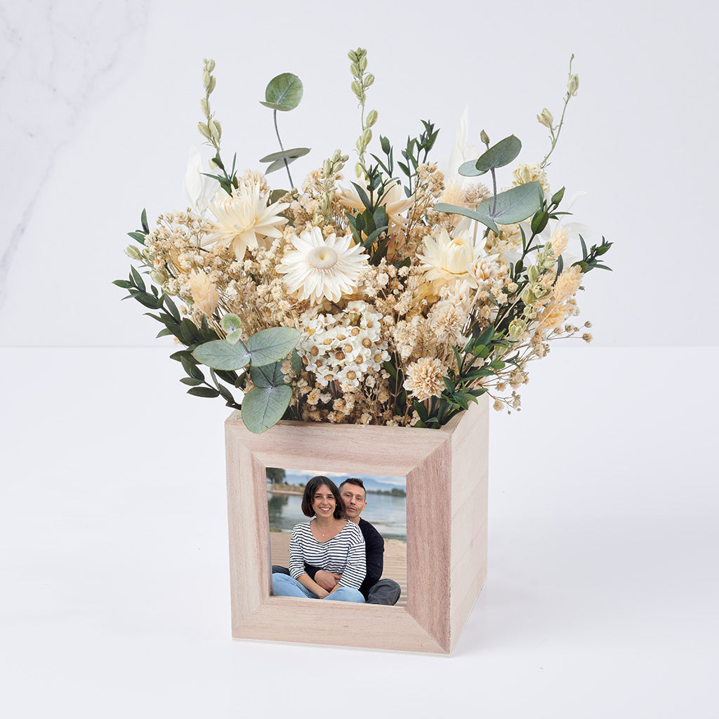 centro de flores preservadas con foto y flores blancas