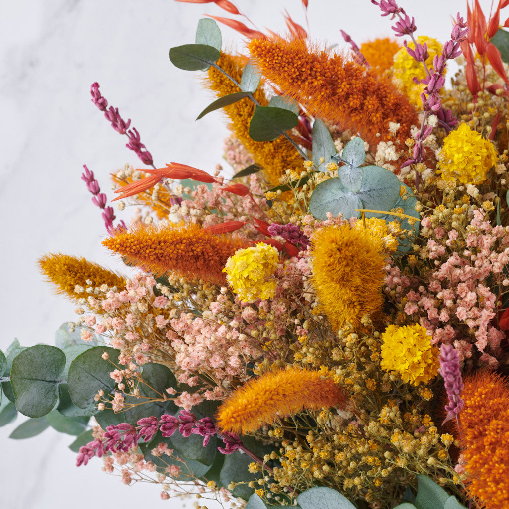 detalle de ramo de flores naranjas preservadas con eucaliptus